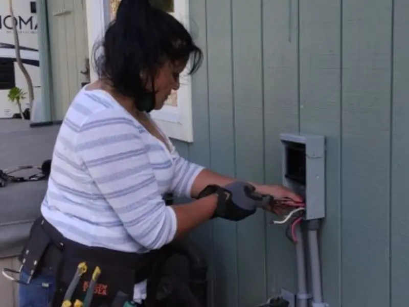 Licensed electrician wiring an exterior subpanel in Wolfforth